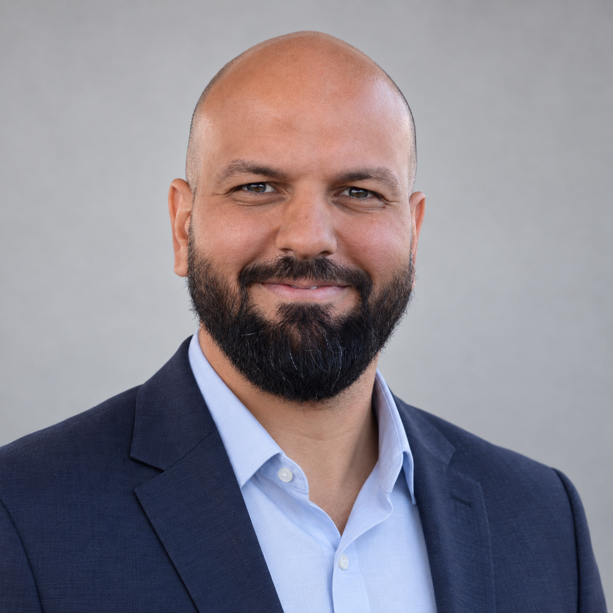 Marwan Alkateb in a navy jacket and light blue shirt
